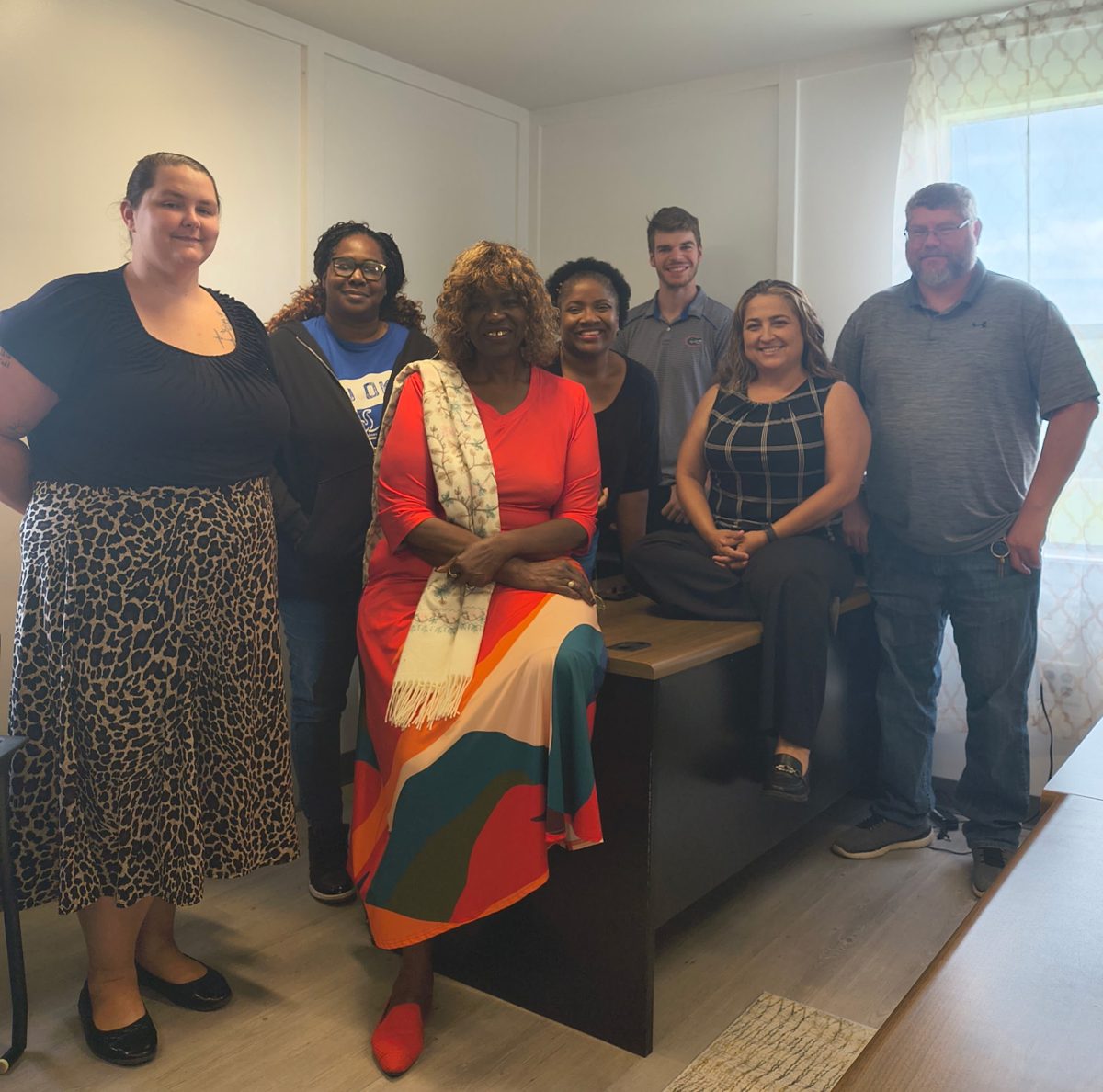 The Florida Scholars Academy team standing together in a classroom building